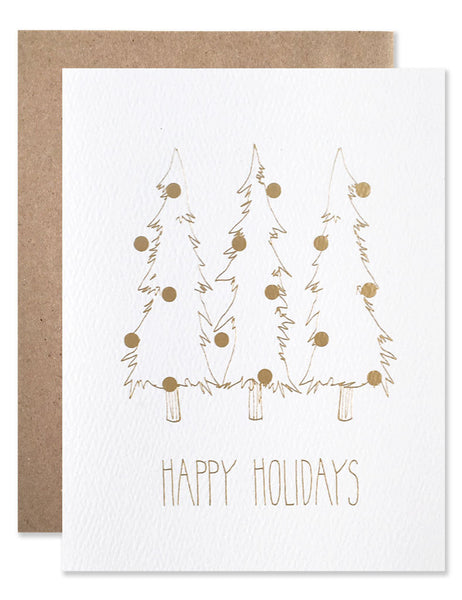 Three slender pine trees with ornaments illustrated by Hartland Brooklyn in gold foil