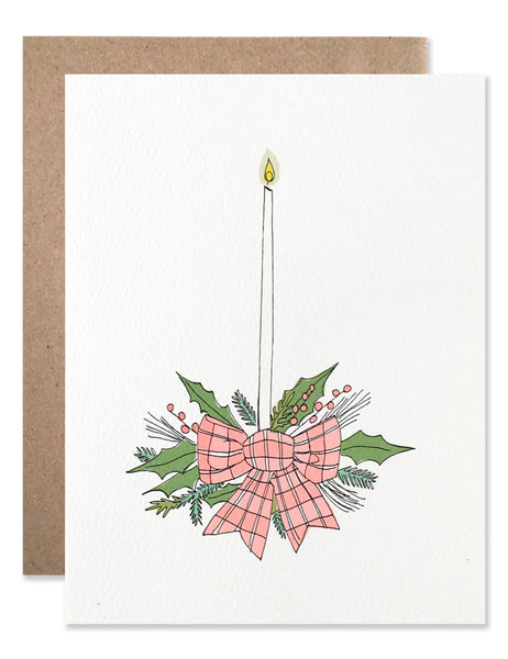 Holiday arrangement with a plaid bow and tall skinny candle illustrated by Hartland Brooklyn